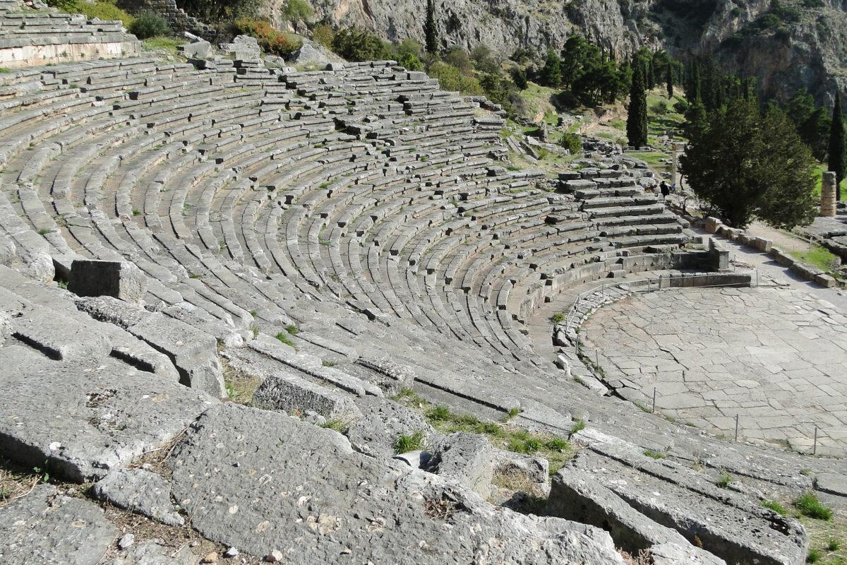 Delphi: ancient theater stands in the sanctuary of Apollo, mountains in the background