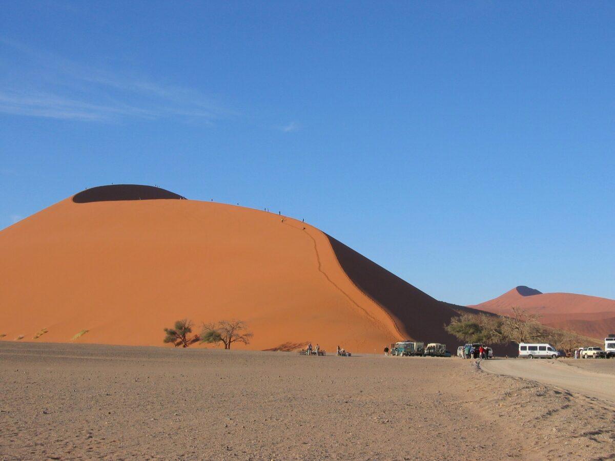 Namibia tourism: Dune 45 at Sossusvlei in the Namib Desert, blue sky and orange sand