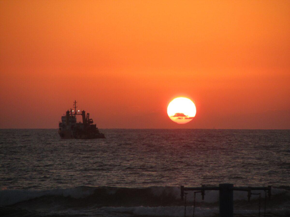 Sunset over the Mediterranean Sea with boat silhouette
